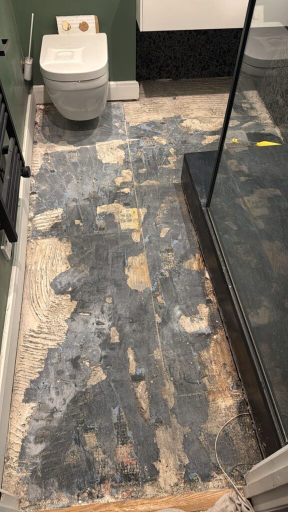 Stripped and uneven bathroom floor surface, ready for installation